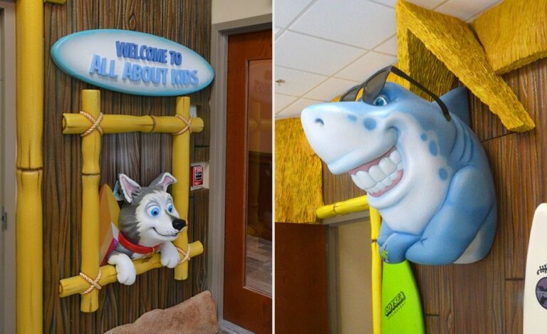 friendly dog and smiling shark mascots mounted on wall