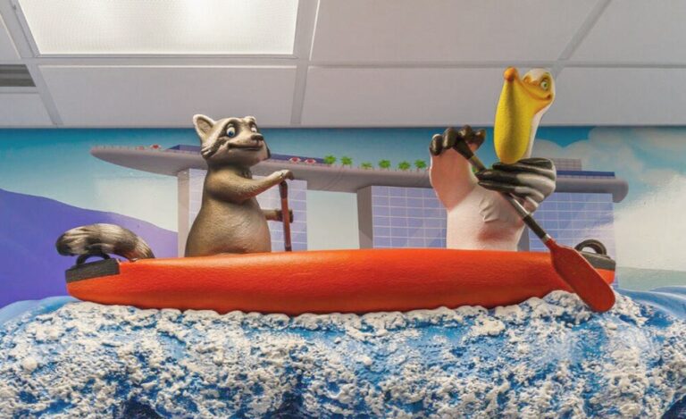 friendly raccoon and pelican characters rafting above a kids dental treatment room