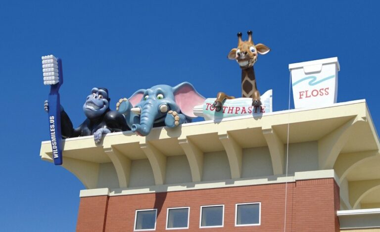 giant gorilla elephant and giraffe rooftop sculptures with giant toothbrush toothpaste and floss