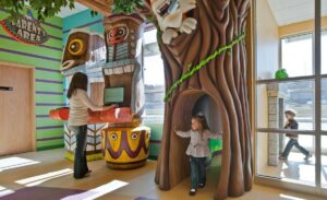 giant tiki checkin desk and tree entrance sculpture in kids dental office