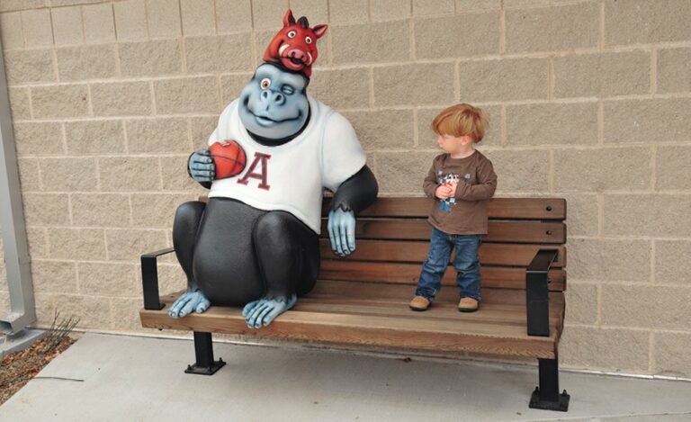 gorilla photo op bench with a child standing beside it