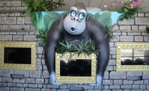 gorilla sculpture holding a gaming screen in kids dental office waiting area
