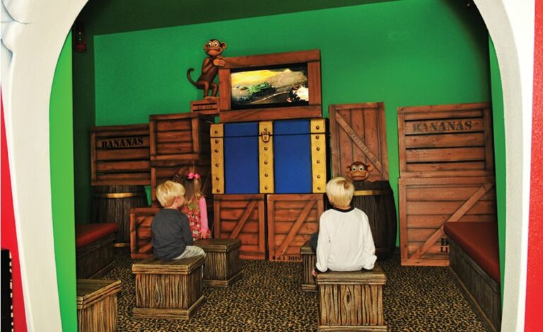 interior decor of a dental office theatre room with crate themed wall cladding and seating