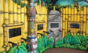 jungle themed gaming area with bamboo foliage and murals