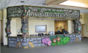 jungle ruins themed reception desk in pediatric dental office