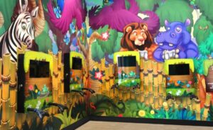 jungle themed murals and game units in pediatric waiting room