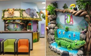 jungle themed reception desk with friendly animal heads and a sculpted 3D waterfall