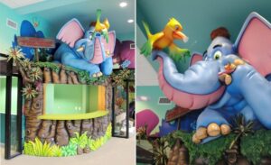 jungle tree reception desk with elephant and parrot sculptures in pediatric dentist