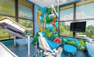kid friendly treatment room with lush jungle scenery murals and cute animals