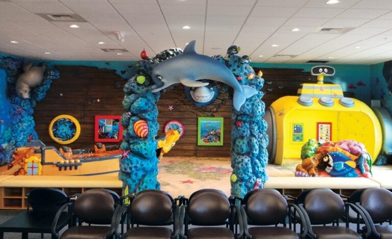 kids play area filled with sculpted coral and submarine games room