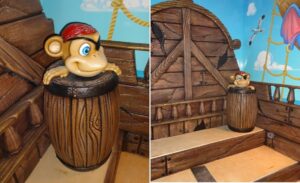 kids play area with money in barrel character and pirate ship theme