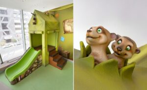 kids play area with tent and slide with meerkats poking through tent roof