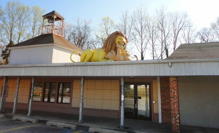 lion and cub sculpture above entrance to a kids dentistry