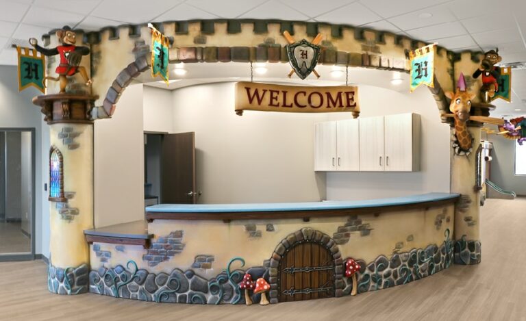 medieval castle reception desk in kids dental office with custom monkey and giraffe sculptures