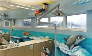 ocean themed treatment room with dolphin and water ski sculptures