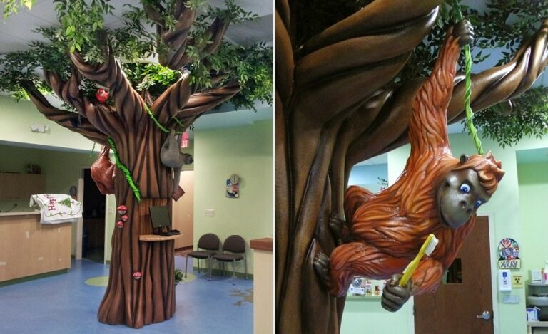orangutan hanging from sculpted jungle tree in pediatric waiting room