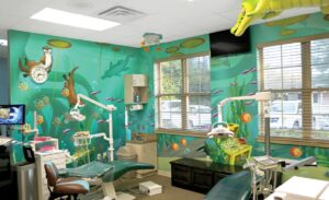 Pediatric treatment bay with sculpted animals and underwater mural
