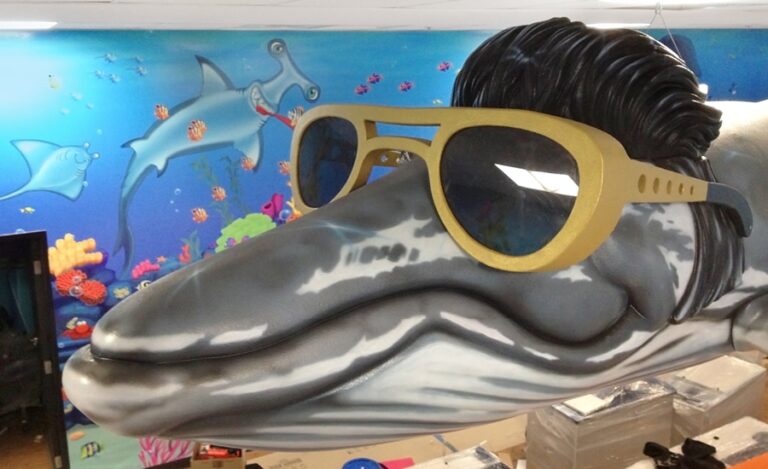 photographer shark and dolphin sculptures in kids treatment room