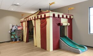 play tent with slide and medieval elephant guard in kids play area