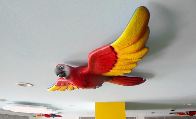 red and yellow sculpted bird in cafeteria of pediatric medical clinic