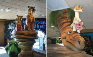 sabertooth tiger and dinosaur sculptures in kids theater area