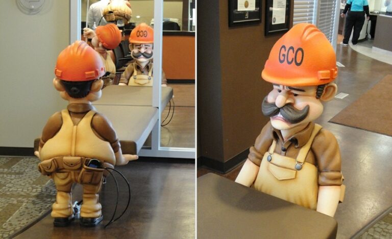 sculpted construction worker holding up bench as custom seating for a dental clinic