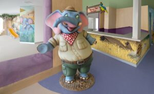 sculpted elephant greeter character at pediatric hospital check-in desk