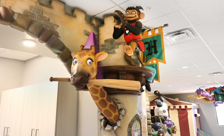 sculpted giraffe and monkey playing baseball at pediatric office reception