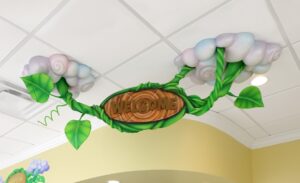 sculpted vine welcome sign in reception area coming out of ceiling