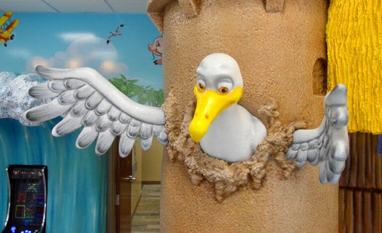 seagull popping out of sandcastle in a beach themed dental office