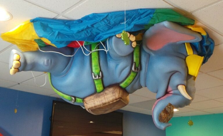 side view of custom ceiling mounted elephant skydiving for a pediatric waiting area