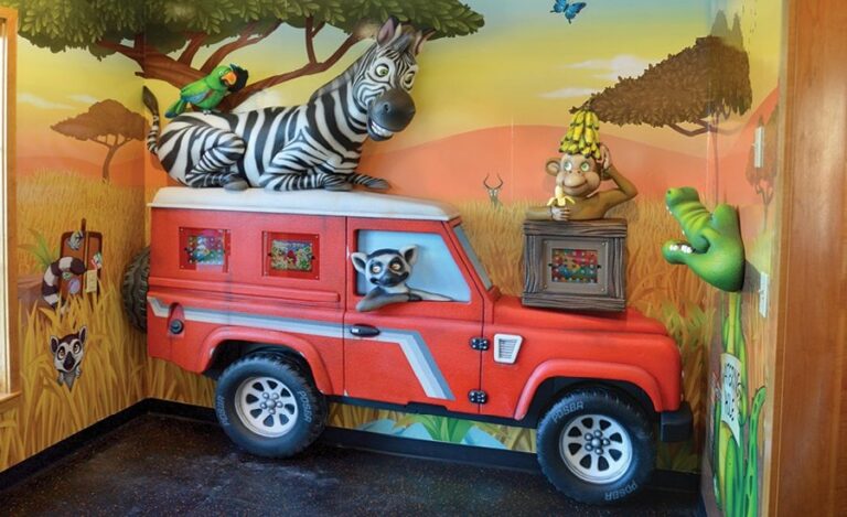 themed games area with sculpted jeep and safari animals for a pediatric office