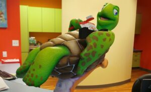 turtle being held up by octopus arm on top of dental clinic reception