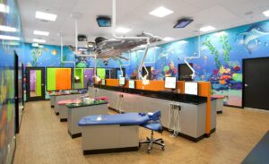 underwater murals and whale sculpture in pediatric dental treatment room