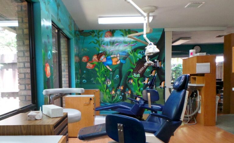 wetland mural with dentist caricature and colorful fish in dental operating bay