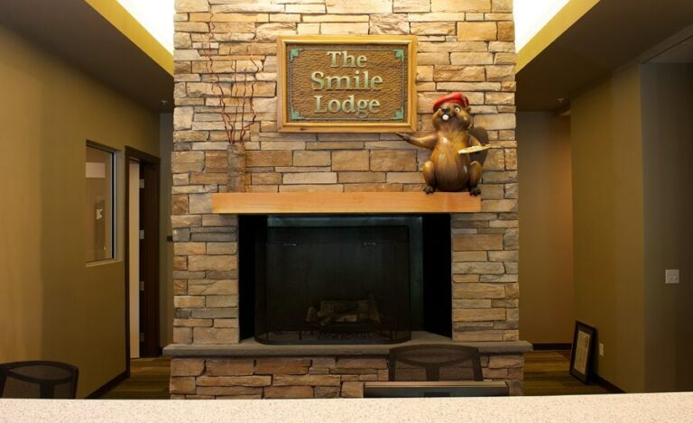wooden lodge inspired signage with a sculpted beaver mascot for an office reception desk