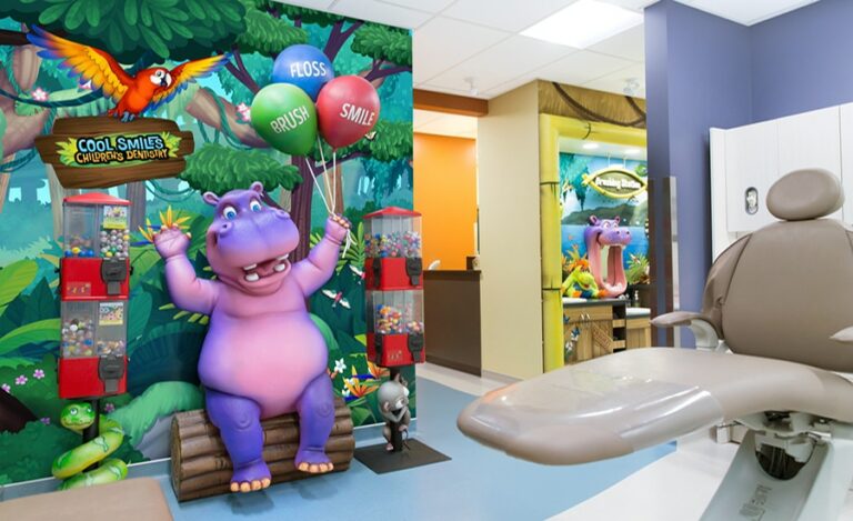 sculpted hippo character holding balloons for kids to take a photo with
