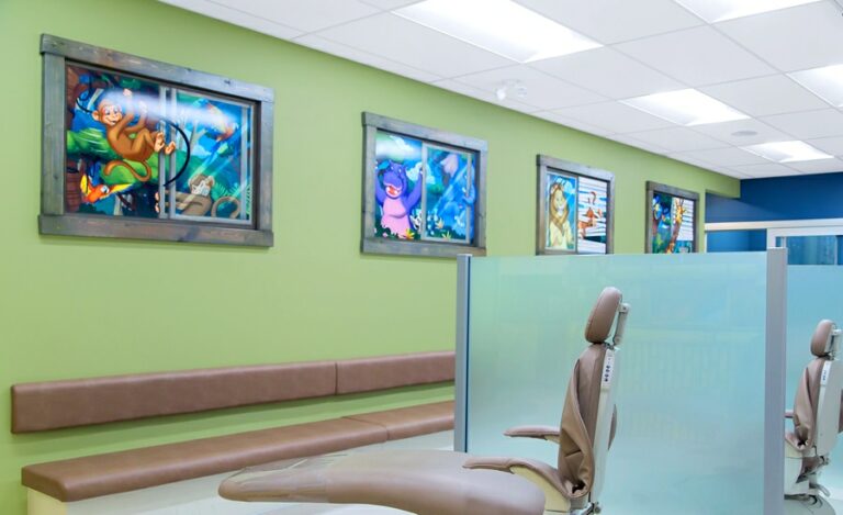 wall artwork in a treatment bay featuring jungle animals peering in through windows