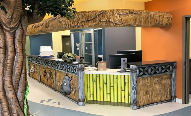 reception desk in a dental office with straw hut themed cladding