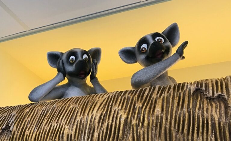 2 sculpted lemur characters looking surprised greet patients in a pediatric clinic