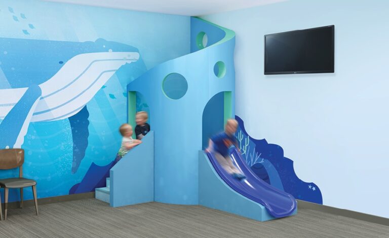 Contemporary coral play slide with stylish whale mural.