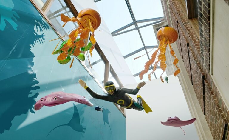 suspended sculpted jellyfish, stingray and diver decor in a hospital hallway