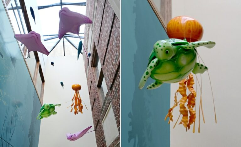 suspended sculpted sea turtle, jellyfish, and sting ray hanging from a hospital ceiling