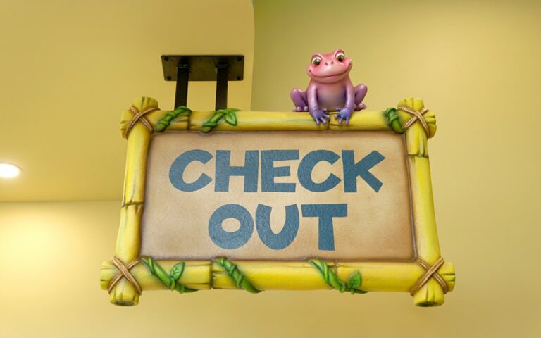 Jungle themed wayfinding 'check out' sign with a pink frog on top.