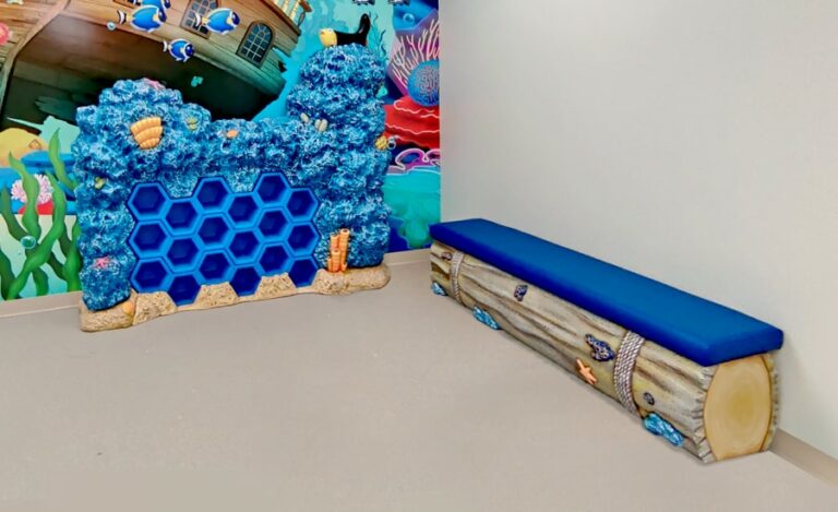 Coral themed shoe cubby beside ocean themed bench seating.