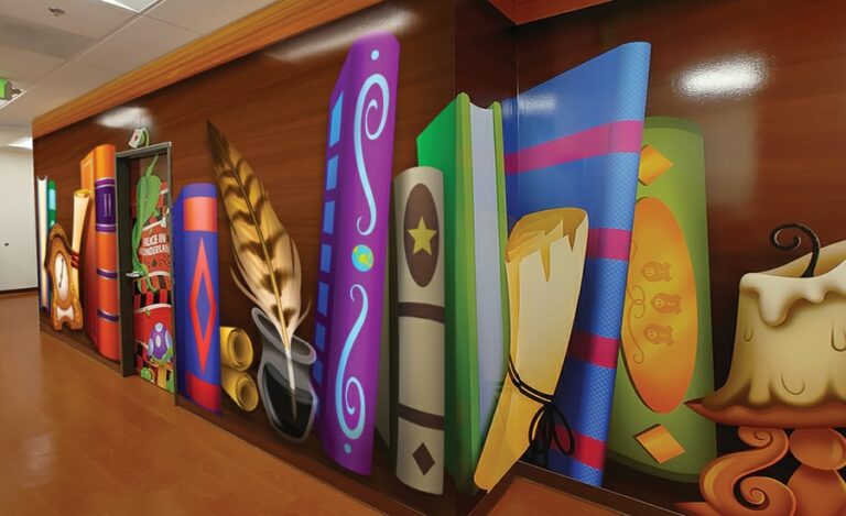 Hallway lined with murals designed to look like a giant bookcase.