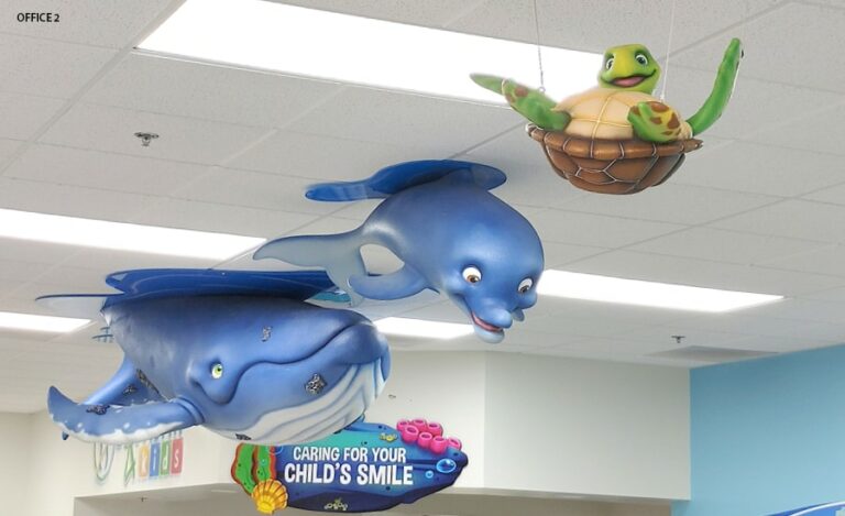 Kid friendly whale, dolphin, and turtle characters hanging from the ceiling.