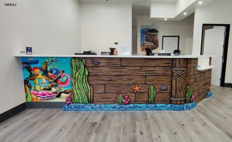 Reception desk outfitted with an underwater themed mural and 3D cladded siding.