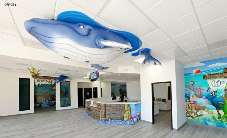 Giant blue whale hung from the ceiling in underwater themed reception area.