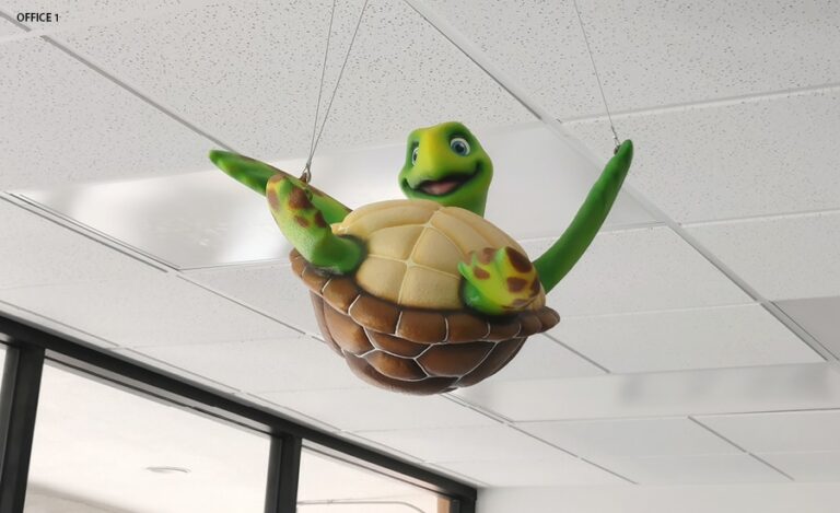 3D sculpted turtle hanging from the ceiling.